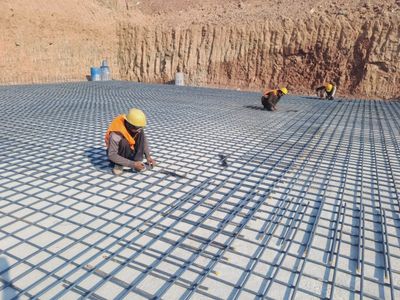 ZCL workers laying steel reinforcement on a foundation